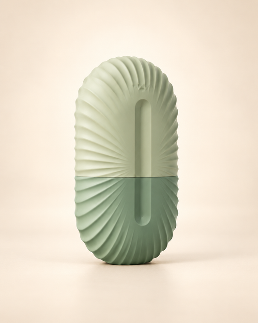 Sage facial ice roller mold on a warm ivory studio background